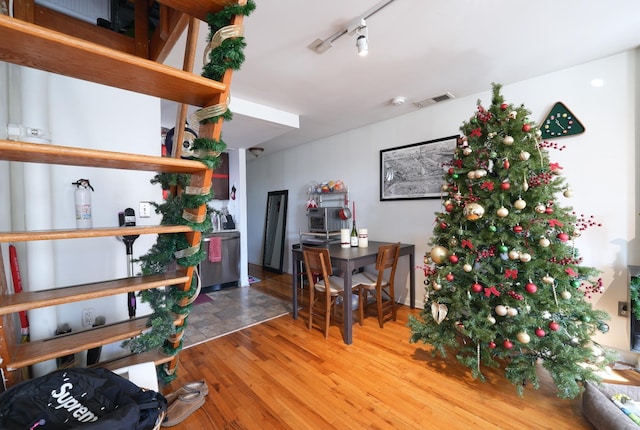 interior space with hardwood / wood-style floors and rail lighting