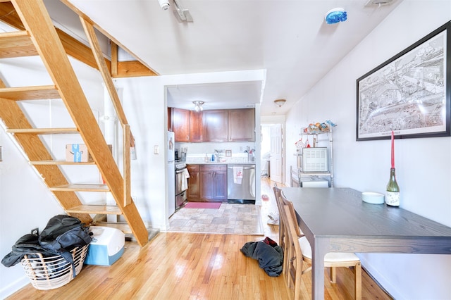 kitchen with stainless steel appliances and light hardwood / wood-style flooring