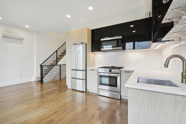 unfurnished living room with sink and light wood-type flooring