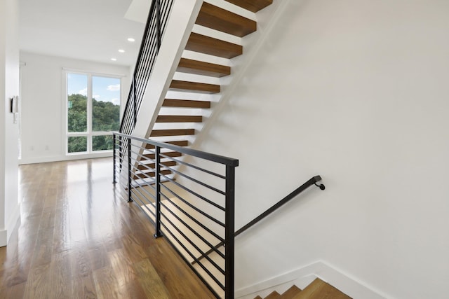 stairs featuring wood-type flooring