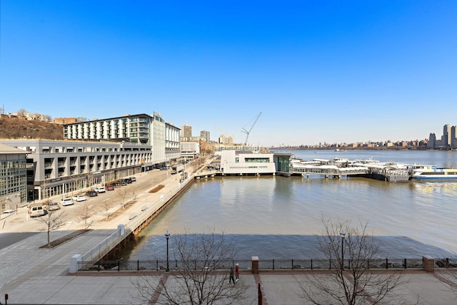 view of dock featuring a view of city and a water view