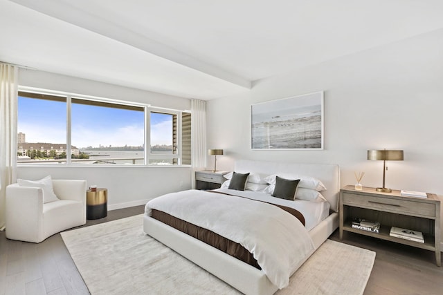 bedroom with baseboards and wood finished floors