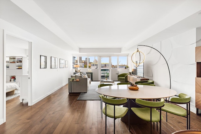 dining room featuring baseboards and dark wood-style floors