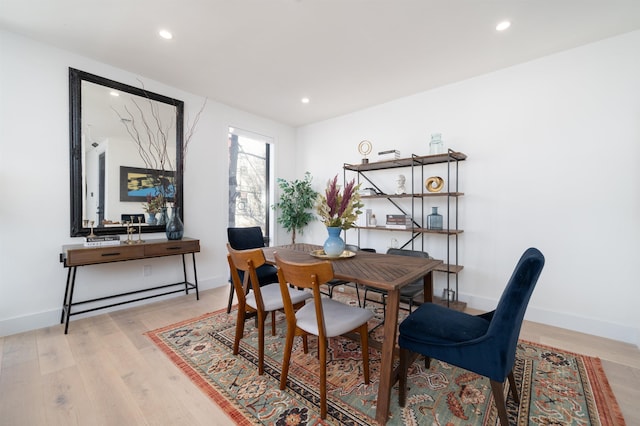 dining room with light wood-style flooring, baseboards, and recessed lighting