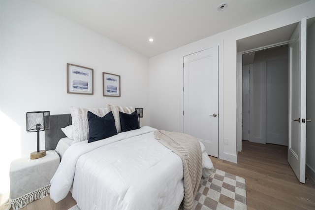 bedroom featuring wood finished floors and recessed lighting