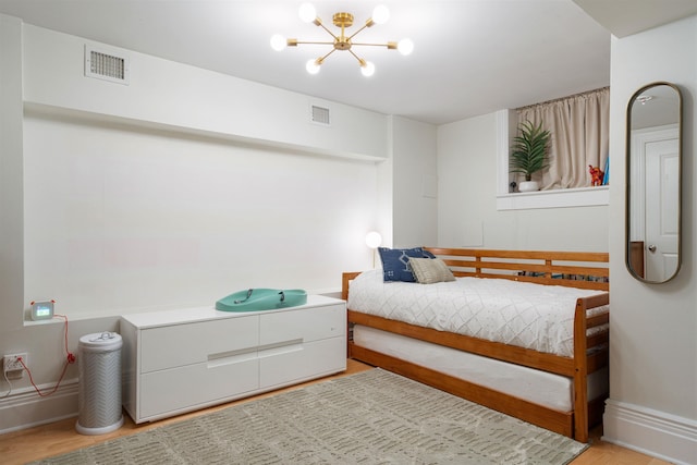 275 5th St Unit 1, Jersey City, NJ 07302 - bedroom featuring light wood-type flooring and a chandelier