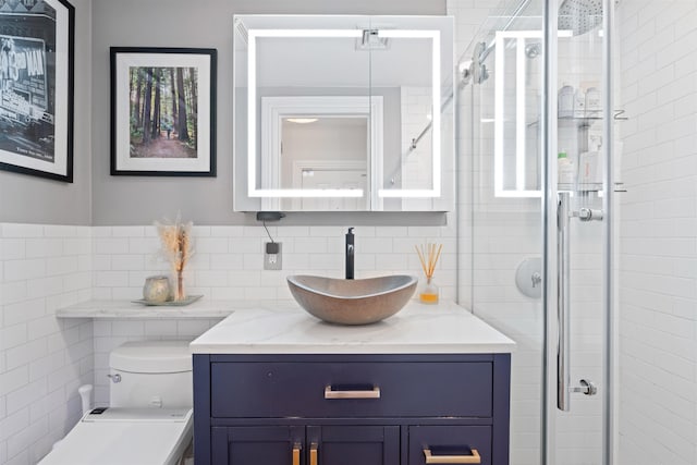 275 5th St Unit 1, Jersey City, NJ 07302 - bathroom featuring vanity, a shower stall, tile walls, and tasteful backsplash