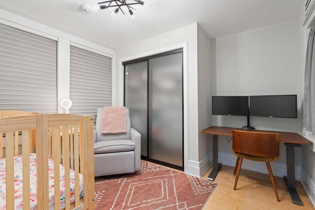 275 5th St Unit 1, Jersey City, NJ 07302 - bedroom featuring wood finished floors, a closet, and a crib