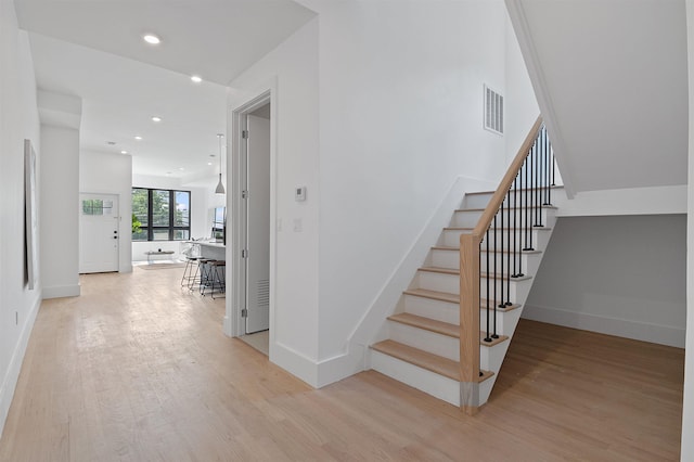 206 Fulton Ave # 2, Jersey City, NJ 07305 - staircase with wood finished floors, baseboards, and recessed lighting