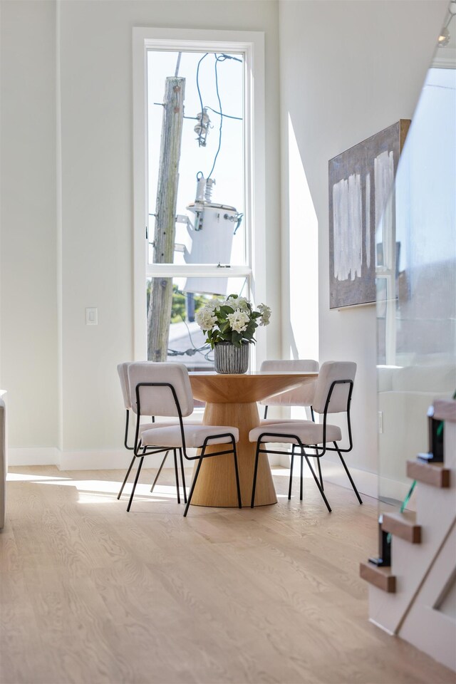 44 Bleecker St Unit 2, Jersey City, NJ 07307 - dining room with healthy amount of natural light, baseboards, and wood finished floors