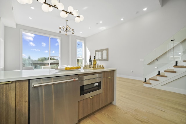 44 Bleecker St Unit 2, Jersey City, NJ 07307 - kitchen with dishwasher, brown cabinetry, light wood-type flooring, light countertops, and modern cabinets