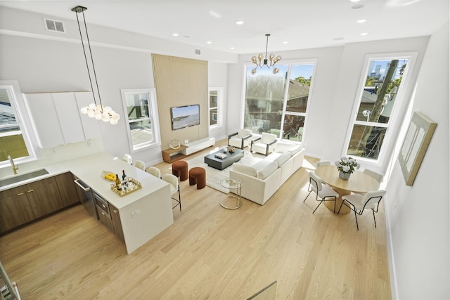 44 Bleecker St Unit 2, Jersey City, NJ 07307 - living room featuring a chandelier, light wood finished floors, recessed lighting, and baseboards