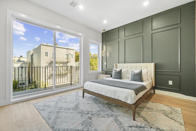 44 Bleecker St Unit 2, Jersey City, NJ 07307 - bedroom featuring access to exterior, multiple windows, light wood finished floors, and recessed lighting