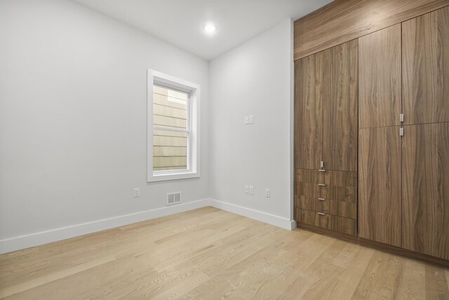 44 Bleecker St Unit 2, Jersey City, NJ 07307 - unfurnished bedroom featuring light wood finished floors, baseboards, and a closet
