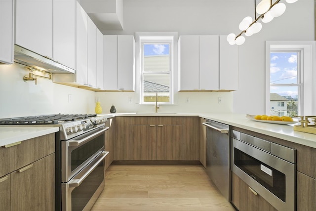44 Bleecker St Unit 2, Jersey City, NJ 07307 - kitchen featuring stainless steel appliances, a sink, modern cabinets, and light wood-style floors