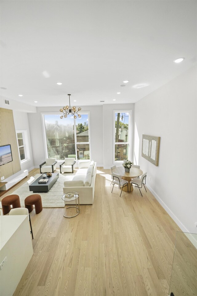 44 Bleecker St Unit 2, Jersey City, NJ 07307 - living area featuring light wood finished floors, baseboards, recessed lighting, and a chandelier