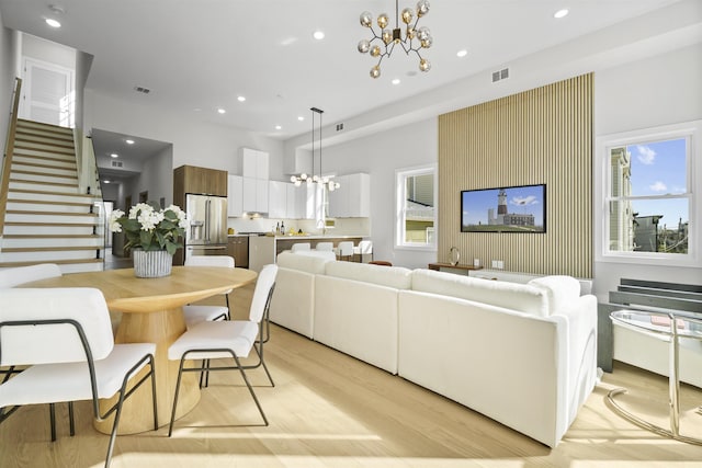 44 Bleecker St Unit 2, Jersey City, NJ 07307 - living room with a chandelier, light wood-style floors, stairs, recessed lighting, and healthy amount of natural light