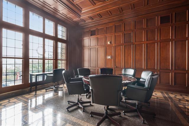 office featuring ornamental molding and wooden walls