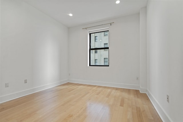 empty room with light hardwood / wood-style flooring