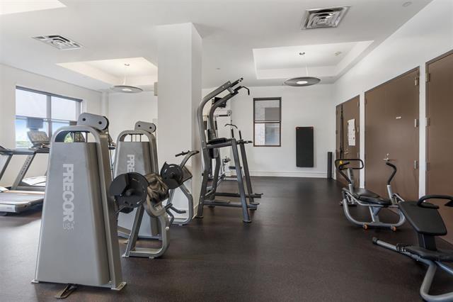 exercise room featuring a raised ceiling