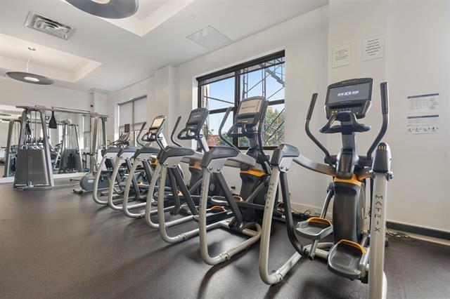 exercise room with a tray ceiling