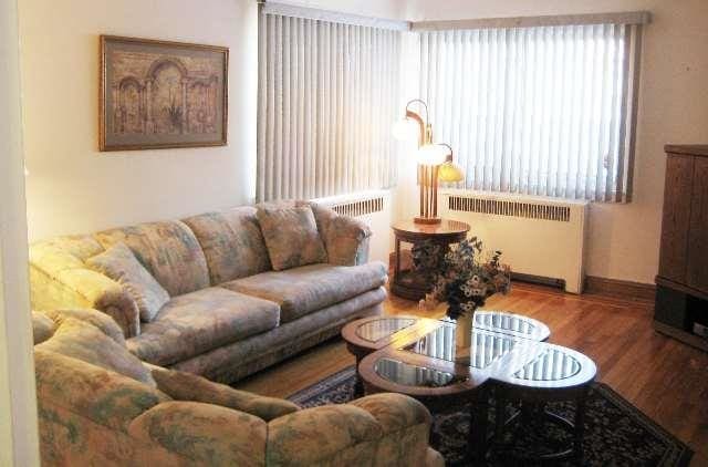 living room featuring radiator and hardwood / wood-style floors