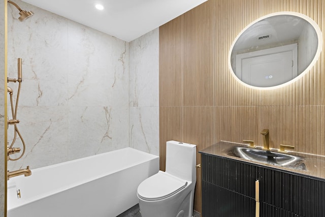 bathroom with toilet, vanity, tile walls, and a bath