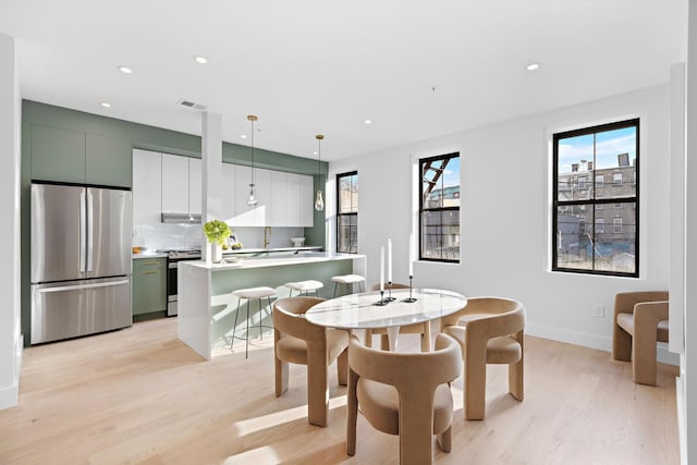 dining space featuring light hardwood / wood-style flooring