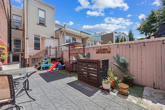 75 Poplar St, Jersey City, NJ 07307 - fenced backyard with a patio, a grill, outdoor dining area, and a residential view