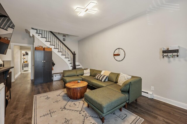 75 Poplar St, Jersey City, NJ 07307 - living area featuring stairway, dark wood-style flooring, and a baseboard heating unit