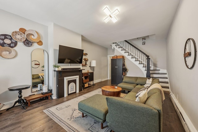 75 Poplar St, Jersey City, NJ 07307 - living room featuring a baseboard radiator, stairway, wood finished floors, and arched walkways