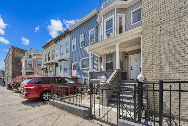 75 Poplar St, Jersey City, NJ 07307 - multi unit property with a residential view, a fenced front yard, brick siding, and covered porch