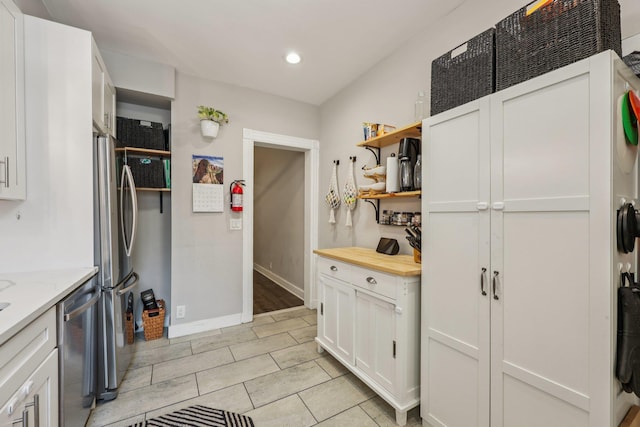 75 Poplar St, Jersey City, NJ 07307 - kitchen with open shelves, appliances with stainless steel finishes, recessed lighting, white cabinets, and light stone countertops