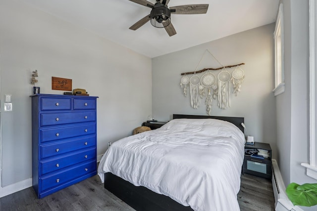 75 Poplar St, Jersey City, NJ 07307 - bedroom featuring dark wood finished floors, a ceiling fan, and a baseboard radiator