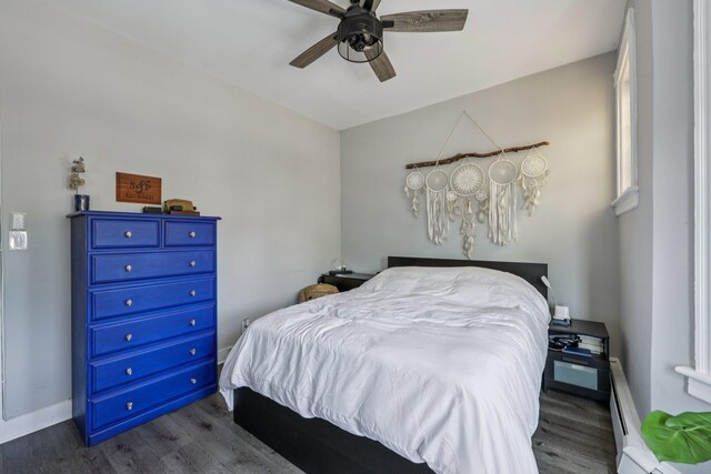 75 Poplar St, Jersey City, NJ 07307 - bedroom featuring dark wood finished floors, a ceiling fan, and a baseboard radiator