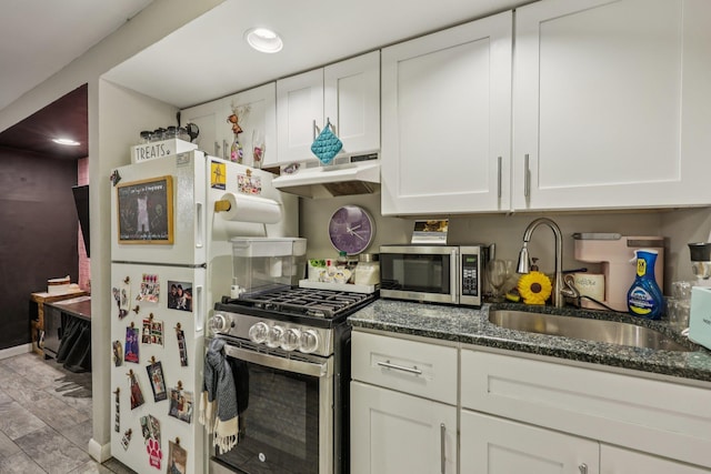 75 Poplar St, Jersey City, NJ 07307 - kitchen with stainless steel appliances, under cabinet range hood, white cabinetry, dark stone countertops, and recessed lighting