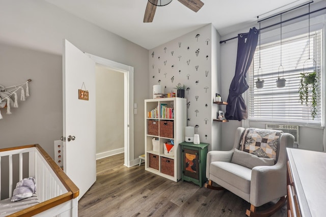 75 Poplar St, Jersey City, NJ 07307 - bedroom with wood finished floors, cooling unit, wallpapered walls, ceiling fan, and a nursery area
