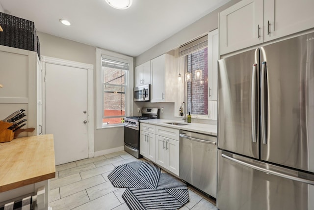 75 Poplar St, Jersey City, NJ 07307 - kitchen with appliances with stainless steel finishes, light countertops, white cabinetry, and recessed lighting