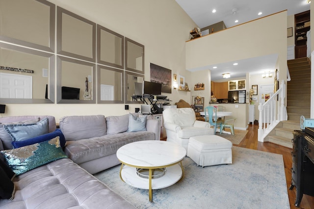 living room with a high ceiling and wood-type flooring