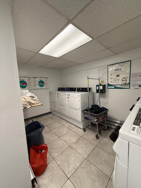 603 55th St Unit 204, West New York, NJ 07093 - community laundry room featuring washing machine and dryer and light tile patterned floors