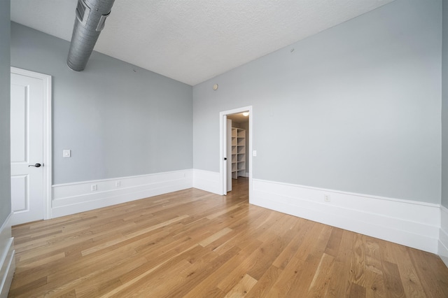 100 Paterson Plank Rd Unit 229, Jersey City, NJ 07030 - spare room with light wood-style flooring, a textured ceiling, and baseboards