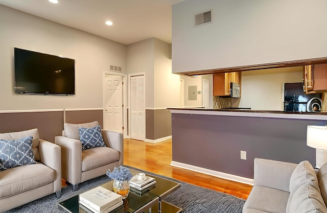 187 Wayne St Unit 208C, Jersey City, NJ 07302 - living room featuring light wood finished floors, recessed lighting, and electric panel