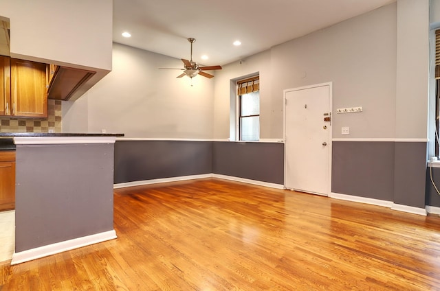 187 Wayne St Unit 208C, Jersey City, NJ 07302 - kitchen featuring light wood-style floors, brown cabinetry, recessed lighting, ceiling fan, and decorative backsplash
