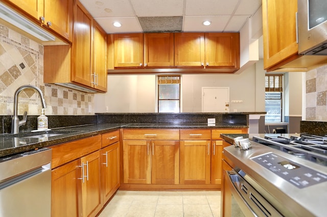 187 Wayne St Unit 208C, Jersey City, NJ 07302 - kitchen featuring dishwasher, brown cabinets, light tile patterned floors, a paneled ceiling, and recessed lighting