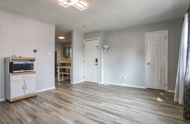 252 N St # 201, Jersey City, NJ 07307 - unfurnished living room featuring light wood-style floors and baseboards