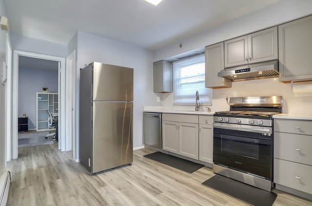 252 N St # 201, Jersey City, NJ 07307 - kitchen featuring stainless steel appliances, exhaust hood, gray cabinetry, and light wood-style floors