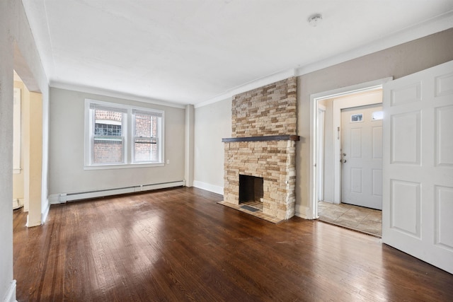 unfurnished living room featuring wood-type flooring, a stone fireplace, ornamental molding, and a baseboard heating unit