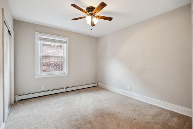 empty room with light carpet, ceiling fan, and a baseboard heating unit