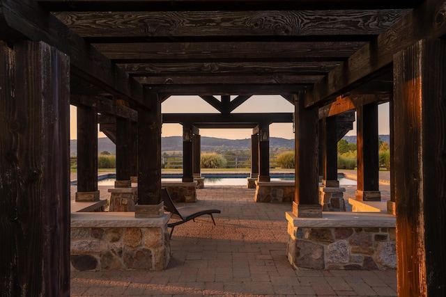 view of community featuring a mountain view and a patio area