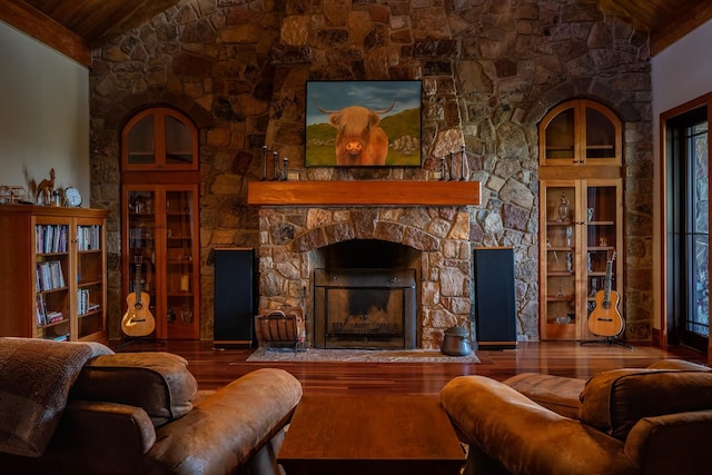 living room featuring vaulted ceiling, a stone fireplace, wood-type flooring, and wood ceiling